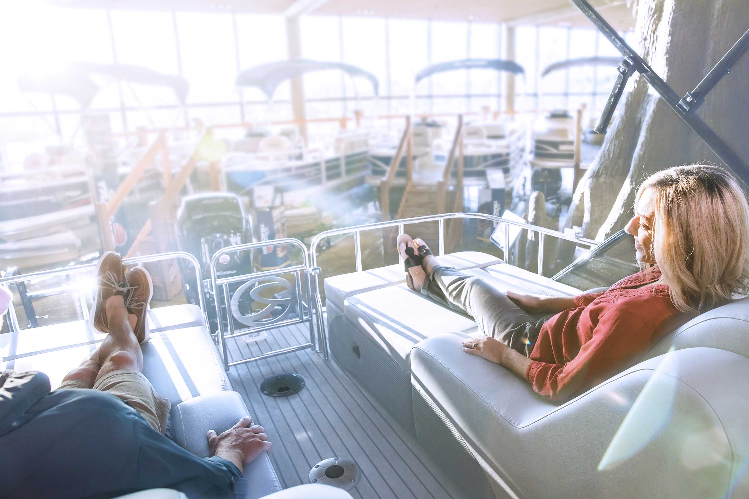 Couple sitting on boat in showroom