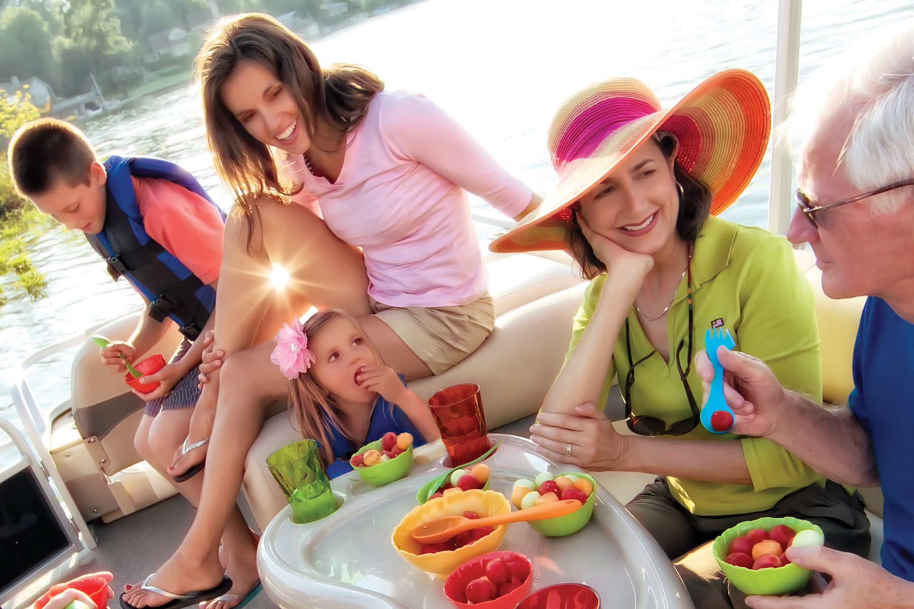 Family enjoying fruit on boat table